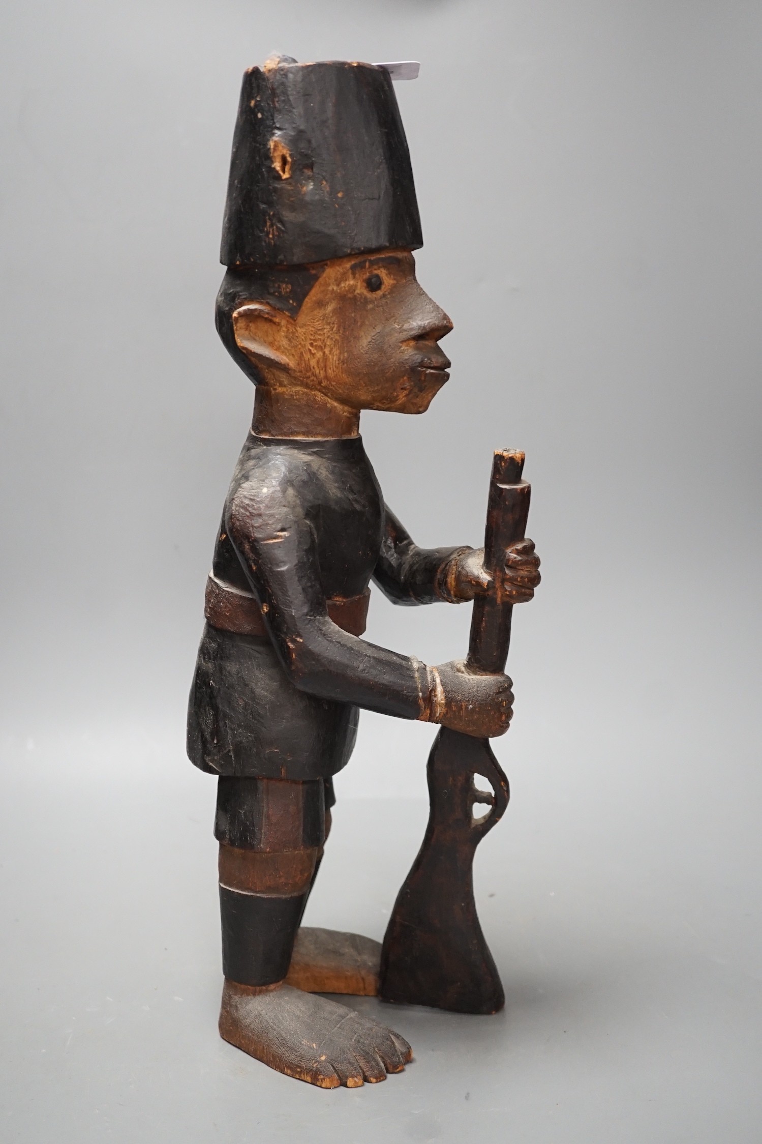 A late 19th century Belgian Congo carved wood figure of a sepoy Height 44 cm